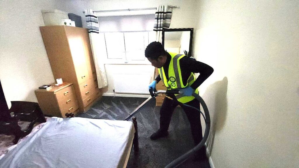 Professional carpet cleaner using specialised equipment to deep clean carpet